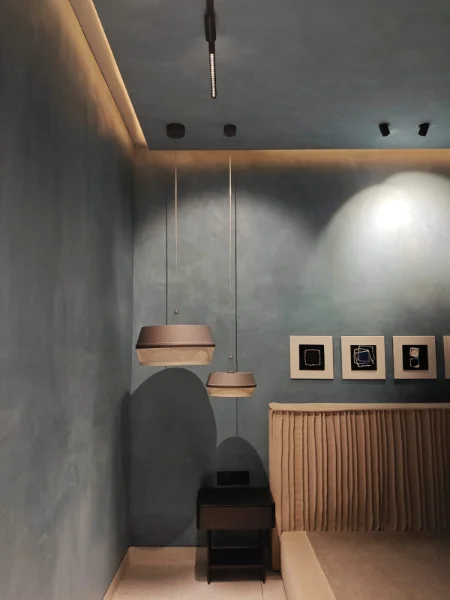 Finished electrical fit-out — pendant lighting and concealed switches in a completed interior